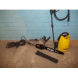 A RYOBI ELECTRIC CHAINSAW AND A POWER WASHER