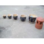 A TERRACOTTA CHIMNEY COWL AND A SELECTION OF CERAMIC PLANTER POTS