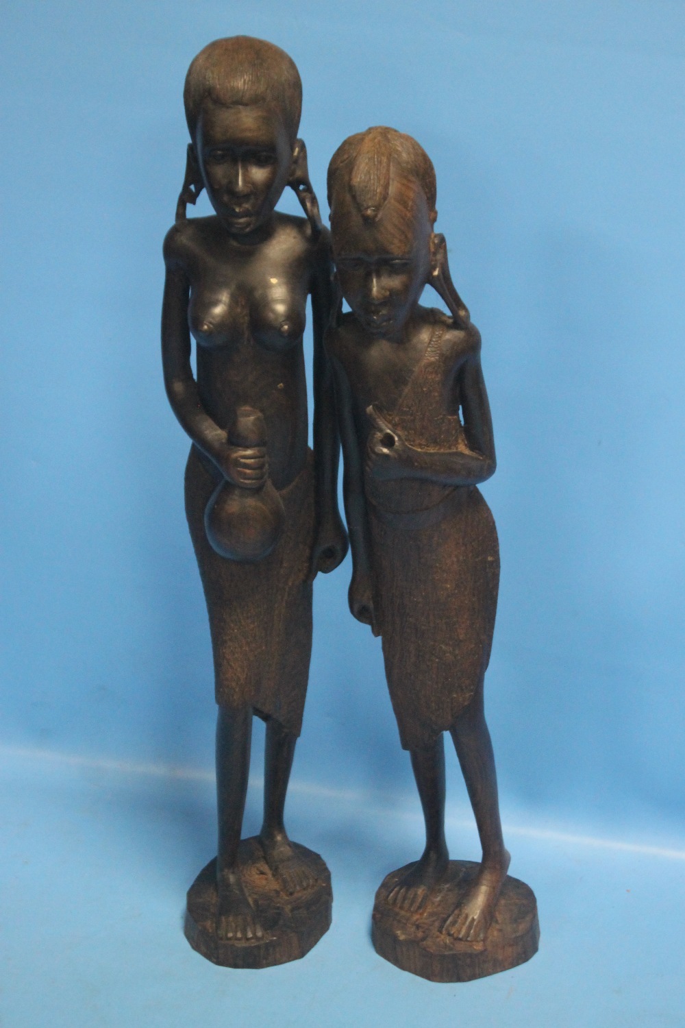 A PAIR OF WOODEN CARVED TRIBAL FIGURESCondition Report:Both missing what should be in their hands