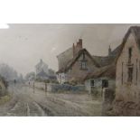 A FRAMED AND GLAZED WATERCOLOUR ENTITLED VILLAGE ON A WET DAY SIGNED HENRY HILTON WITH EXHIBITION