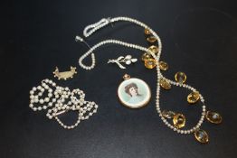 A BAG OF ANTIQUE COSTUME JEWELLERY