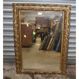 A GILT FRAMED WALL MIRROR OVERALL SIZE - 83CM X 60CM