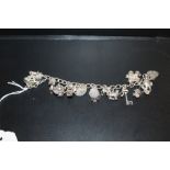 A VINTAGE SILVER CHARM BRACELET