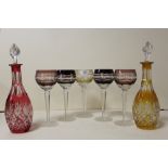 FIVE CUT AND COLOURED WINE GLASSES TOGETHER WITH TWO CUT AND COLOURED GLASS DECANTERS (7)