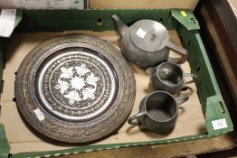 A HAMMERED FINISH PEWTER THREE PIECE TEA SERVICE, TOGETHER WITH A BRASS INLAID CARVED WOODEN CHARGER