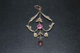AN ANTIQUE 9CT GOLD SEED PEARL AND PINK STONE PENDANT