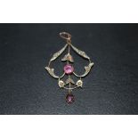 AN ANTIQUE 9CT GOLD SEED PEARL AND PINK STONE PENDANT