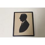 AN ANTIQUE STYLE SILHOUETTE PROFILE OF A GENTLEMAN IN A SUIT SIGNED LOWER RIGHT 13.5CM X 11CM