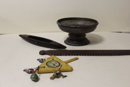 A MOROCCAN BRASS TAZZA. TWO ETHIOPEAN WOODEN WEAVING TOOLS AND A WOODEN PAINTED INDONESIAN CHILD'S