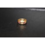 A HALLMARKED GOLD DRESS RING SET WITH RUBIES - HALLMARKS RUBBED APPROX WEIGHT - 2.2G