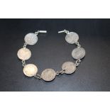 A SILVER VICTORIAN 3D COIN BRACELET