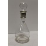 A HALLMARKED SILVER COLLARED GLASS DECANTER