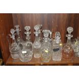 A QUANTITY OF ASSORTED CUT GLASS DECANTERS AND JUGS (12)