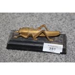 A VINTAGE GILT METAL FIGURE OF A LOCUST ON EBONISED PLINTH OVERALL LENGTH 13CM