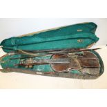 AN ANTIQUE VIOLIN WITH ANIMAL HEAD SCROLL FOR RESTORATION - AS FOUND WITH BOWS AND CASE