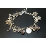 A VINTAGE SILVER CHARM BRACELET