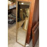 A GILT FRAMED WALL MIRROR OVERALL SIZE - 122CM X 35CM