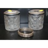 TWO HALLMARKED SILVER TOPPED CUT GLASS VANITY JARS, TOGETHER WITH A HALLMARKED SILVER ENGRAVED