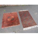 TWO 19TH CENTURY RED WOOLLEN EASTERN RUGS 79 CM X 130 CM AND 90 CM X 100 CM