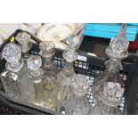 A TRAY OF GLASS DECANTERS TO INCLUDE CUT AND PRESSED GLASS EXAMPLES