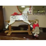 A VINTAGE NAIVE ROCKING HORSE ON A TRESTLE BASE - IN NEED OF RESTORATION AND A DOLL (2)