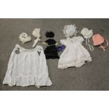 A TRAY OF VINTAGE CHILDRENS & DOLLS BONNETS AND DRESSES