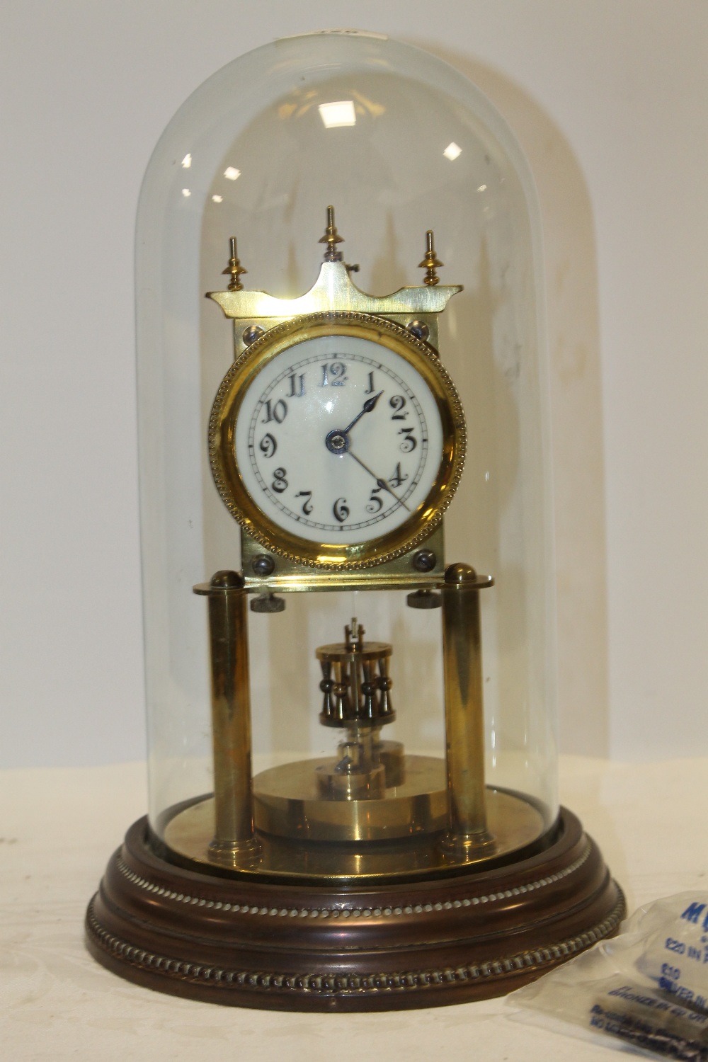 A GLASS DOME TOP BRASS MANTEL CLOCK