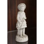 AN ANTIQUE MATTE FINISH FIGURE OF A YOUNG BOY IN A HAT MARKED R&L TO REVERSE H- 24CM