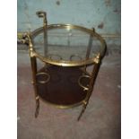 A BRASS ROUND DRINKS TROLLEY