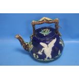 A 19TH CENTURY MAJOLICA TEAPOT DECORATED WITH A WHITE BIRD AND BULL RUSHES