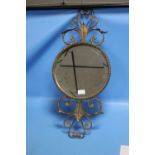 A SMALL CIRCLED BEVEL EDGED MIRROR IN METAL GILT FRAME