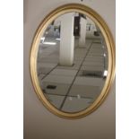 A MODERN OVAL MIRROR