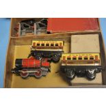 A HORNBY O' GAUGE TRAIN SET WITH OPERATING KEY, TWO PASSENGER CARRIAGES, MILK TRAFFIC VAN WITH 4