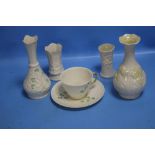 A COLLECTION OF FOUR BELLEEK VASES AND A CUP AND SAUCER