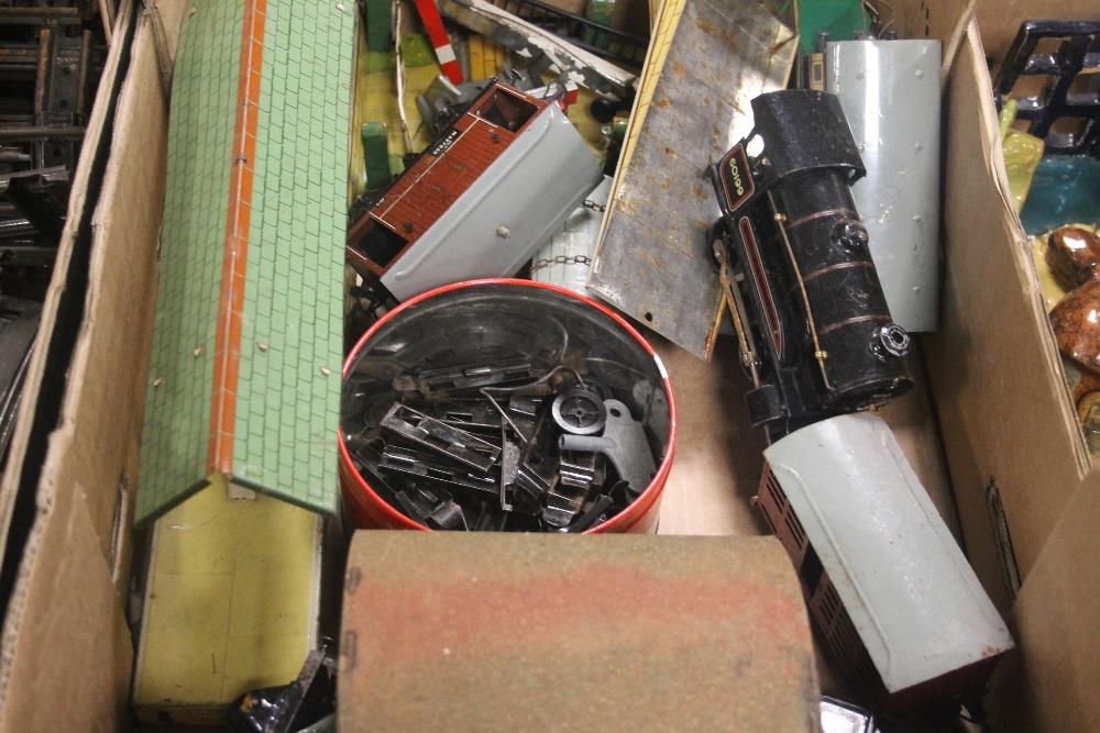 TWO TRAYS OF MODEL RAILWAY TO INCLUDE TIN PLATE ENGINE, CARRIAGES, STATION AND TRACK