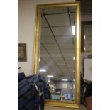 A LARGE GILT FRAMED MIRROR 164 X 64 CM