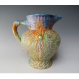 A CLARICE CLIFF RELIEF MOULDED JUG, hand painted in the Delecia pattern with tonal streaked glaze