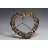 A CHINESE HEART SHAPED PIERCED WHITE METAL DRAGON PHOTO FRAME, with bamboo design easel stand,