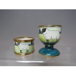 A MOORCROFT SHEEP DESIGN ENAMEL 2PC BREAKFAST SET, comprising an egg cup and napkin ring, with