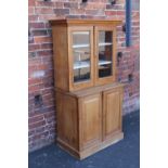 AN EDWARDIAN SATIN BOOKCASE, the twin glazed door upper section above a deeper lower section with