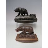 A CARVED BLACK FOREST WOODEN DESK STAND WITH BEAR SURMOUNT, having pen tray and lidded ink well, W