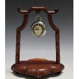 A CHINESE STYLE HARDWOOD POCKET WATCH STAND, with a vintage Ingersoll Ltd pocket watch, H 22 cm