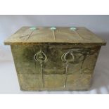 AN ARTS AND CRAFTS RECTANGULAR BRASS BOX WITH HINGED COVER, with raised foliate decoration having