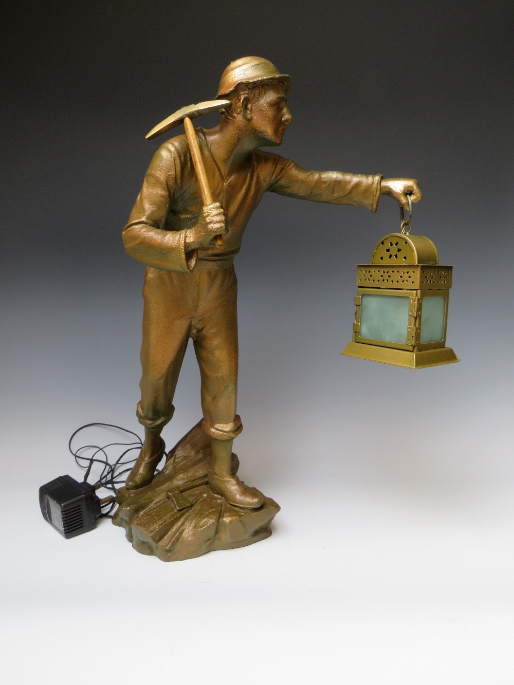 A LARGE SPELTER FIGURE OF A MINER WITH LAMP, the lamp fitted with later LED bulb, H 53 cmCondition