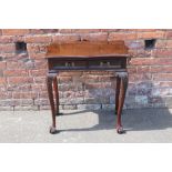 A SMALL 19TH CENTURY MAHOGANY SHAPED TWO DRAWER SIDE TABLE, raised on slender cabriole supports with