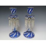 A PAIR OF BLUE AND CLEAR GLASS CANDLE LUSTRES, the pressed glass body with white enamel painted