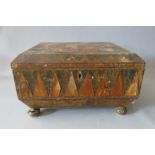 AN ANTIQUE WOODEN PARQUETRY TWIN HANDLED CASKET SHAPED WORK BOX FOR RESTORATION, with label to