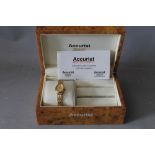 A LADIES ACCURIST 9CT GOLD WRISTWATCH AND STRAP, with instructions and guarantee leaflet, in a