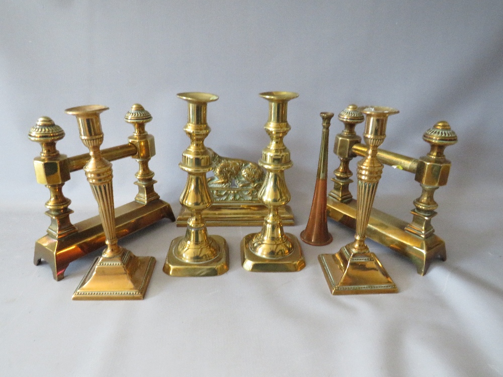 A COLLECTION OF BRASSWARE, to include two pairs of candlesticks, a pair of fire dogs etc