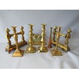 A COLLECTION OF BRASSWARE, to include two pairs of candlesticks, a pair of fire dogs etc